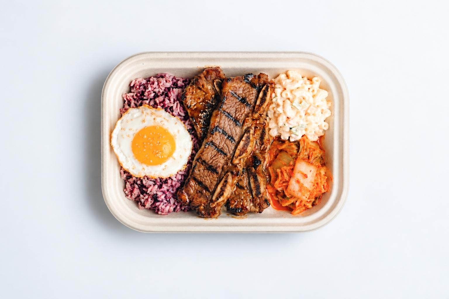 Soban Galbi with grilled beef short ribs, purple rice, fried egg, mac salad and kimchi